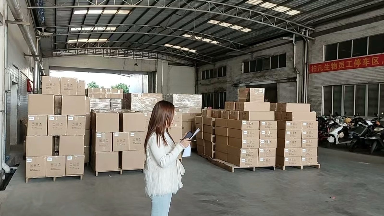 Warehouse floor at a cosmetics OEM factory with finished cartons stacked in rows